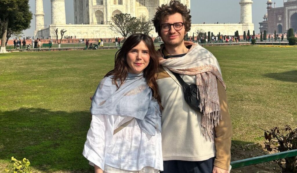 Tourists wearing modest clothing following Taj Mahal dress code guidelines