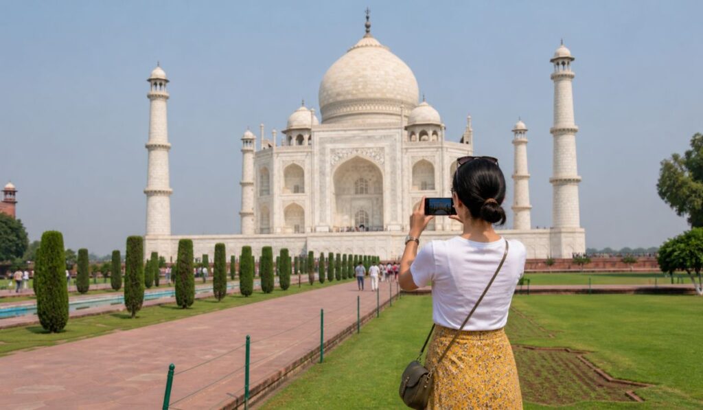Tourist taking photo at Taj Mahal carrying small bag following travel tips and entry rules