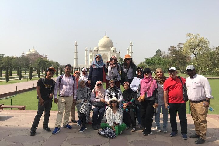 Private Tourist Guide in Agra with international travelers at the Taj Mahal during a guided heritage tour.